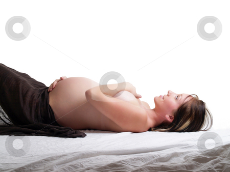To use this stock image in your creative project, please select the size you need over to the right and click the "Add to Cart" button.
Your downloaded image will come with the Cutcaster watermark removed so don’t worry about the watermark you see on this page. Young pregnant woman reclining profile holding stomach covering breasts stock photo, Young pregnant woman covered nude reclining profile by Jeff Cleveland