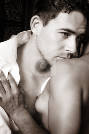 To use this stock image in your creative project, please select the size you need over to the right and click the "Add to Cart" button.
Your downloaded image will come with the Cutcaster watermark removed so don’t worry about the watermark you see on this page. Intimate lovers embrace stock photo, Multi-ethnic couple in passionate embrace and undressing each other during sexual foreplay. B&W defocussed image by Sean Nel