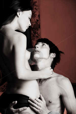 To use this stock image in your creative project, please select the size you need over to the right and click the "Add to Cart" button.
Your downloaded image will come with the Cutcaster watermark removed so don’t worry about the watermark you see on this page. Intimate young lovers stock photo, Young adult Caucasian couple in passionate embrace and undressing each other during sexual foreplay by Sean Nel